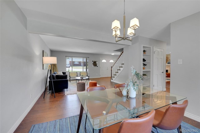 dining area with hardwood / wood-style flooring and an inviting chandelier