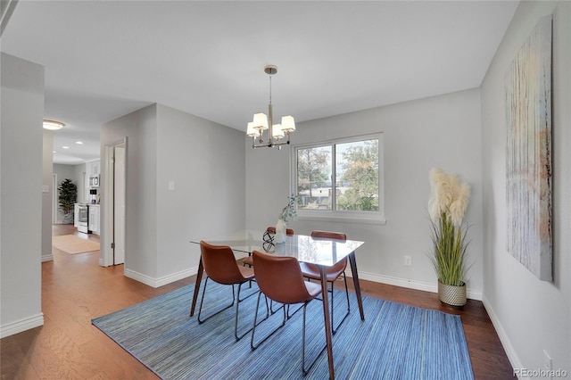 dining area featuring a notable chandelier and wood-type flooring