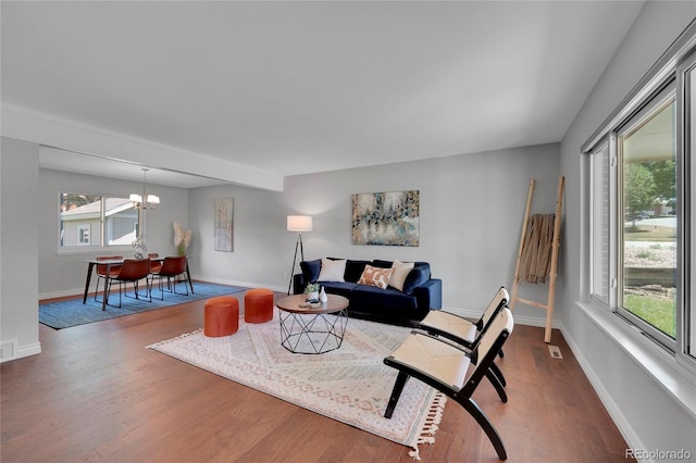 living room featuring hardwood / wood-style floors and an inviting chandelier