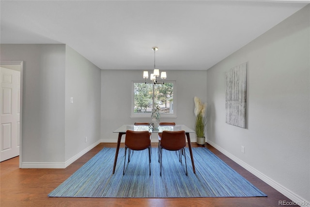 dining space featuring hardwood / wood-style floors and a notable chandelier