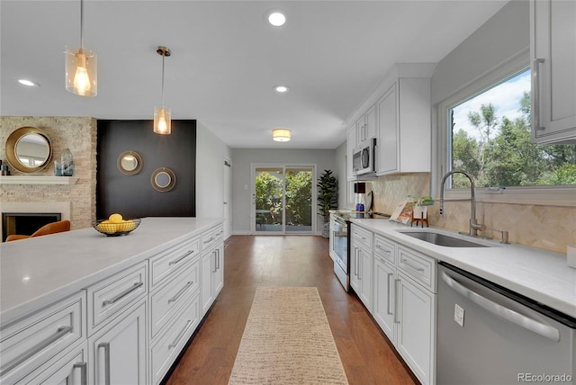 kitchen with sink, white cabinetry, stainless steel appliances, and dark wood-type flooring