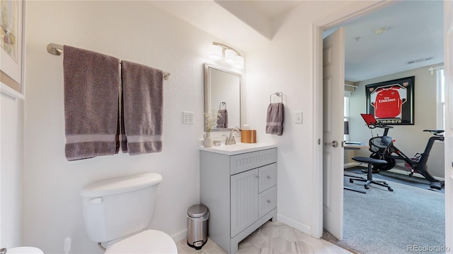 bathroom featuring vanity and toilet