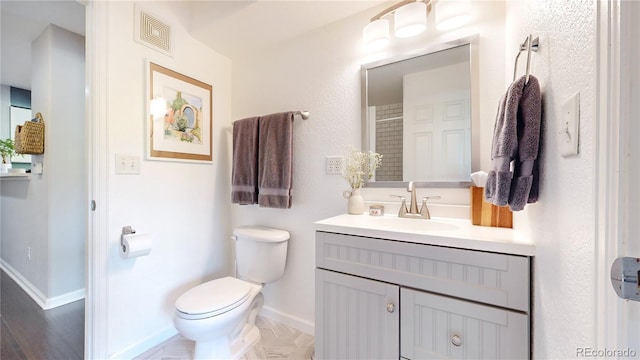 bathroom featuring vanity and toilet