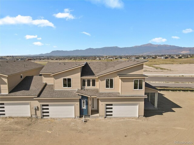 view of front of home featuring a mountain view and a garage