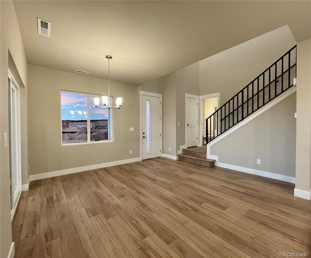 interior space with hardwood / wood-style flooring and an inviting chandelier