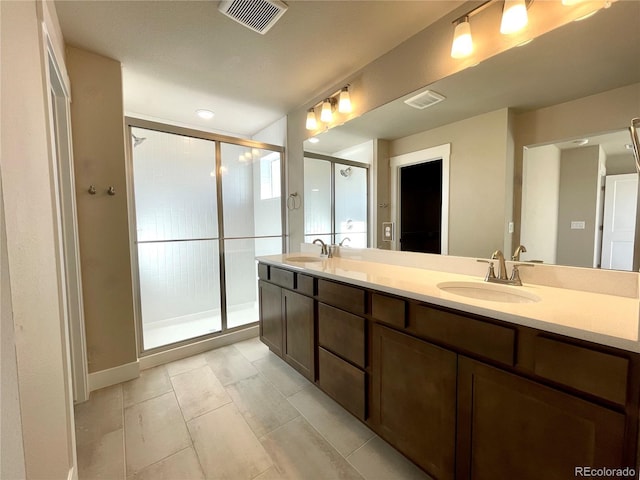 bathroom featuring vanity and a shower with shower door