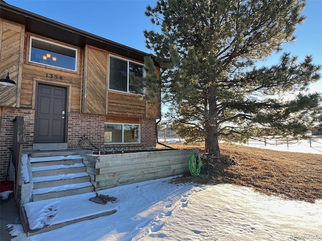 view of snow covered property entrance