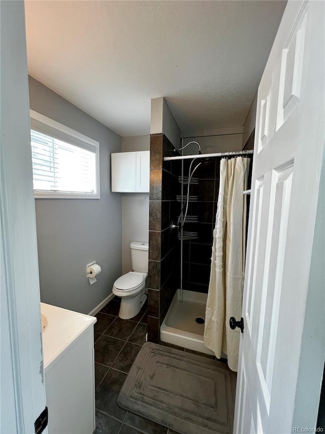 bathroom featuring tile patterned floors, vanity, toilet, and a shower with shower curtain