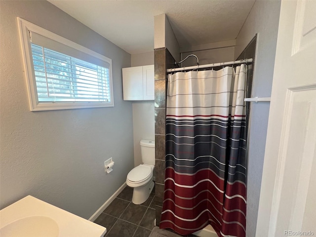 bathroom with curtained shower, toilet, tile patterned floors, and vanity