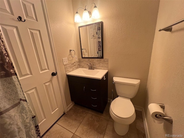 bathroom with backsplash, toilet, vanity, and tile patterned flooring