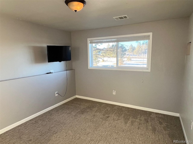 unfurnished bedroom with dark colored carpet