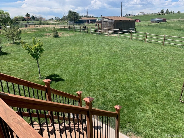 view of yard with an outbuilding and a rural view