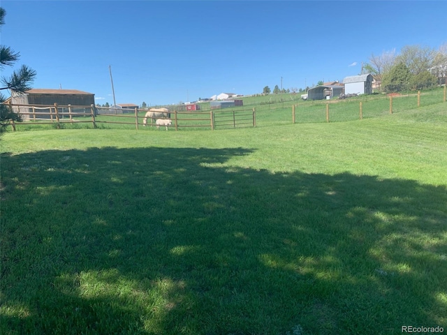 view of yard with a rural view