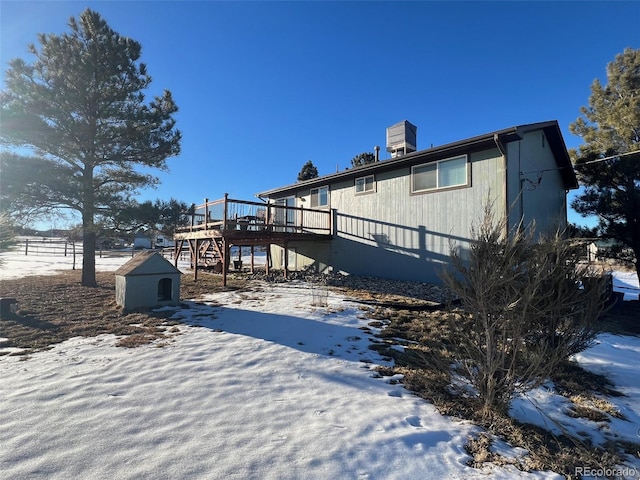 exterior space featuring a wooden deck and a storage shed