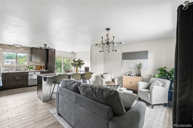 6254 W 79th Ave, Arvada, CO 80003 - living area featuring a chandelier and light wood-type flooring