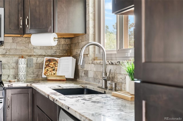 6254 W 79th Ave, Arvada, CO 80003 - kitchen with freestanding refrigerator, dark brown cabinets, decorative backsplash, and light stone counters
