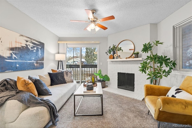 carpeted living area with a brick fireplace, ceiling fan, and a textured ceiling