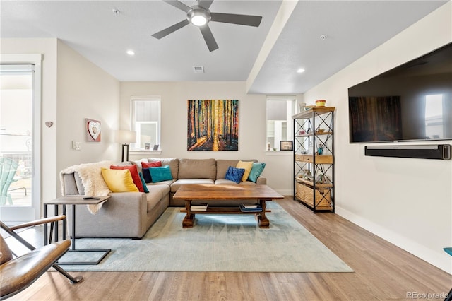 living area with ceiling fan, visible vents, wood finished floors, baseboards, and recessed lighting