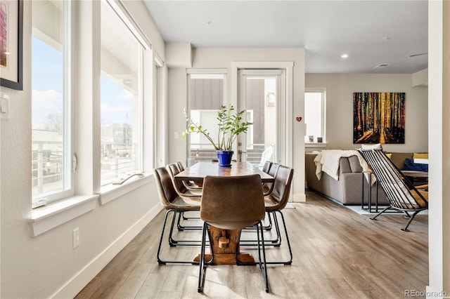 dining room featuring recessed lighting, baseboards, visible vents, and light wood finished floors