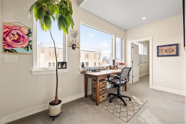 office area featuring baseboards and light colored carpet