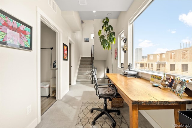 home office with visible vents and carpet flooring