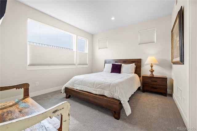 carpeted bedroom featuring baseboards and recessed lighting