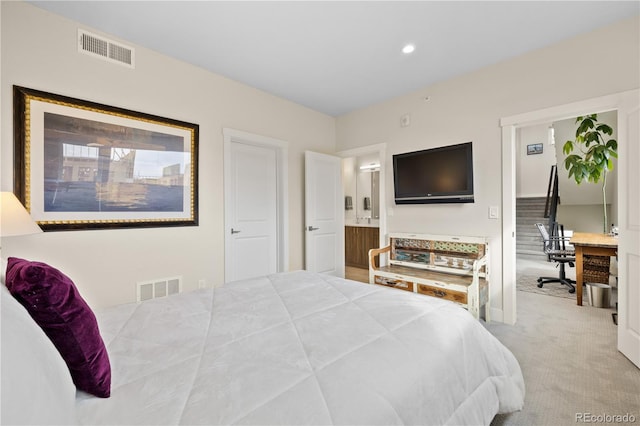 carpeted bedroom with visible vents, recessed lighting, baseboards, and ensuite bathroom