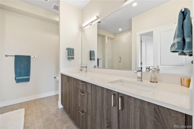 bathroom with tile patterned floors, visible vents, a shower stall, and a sink
