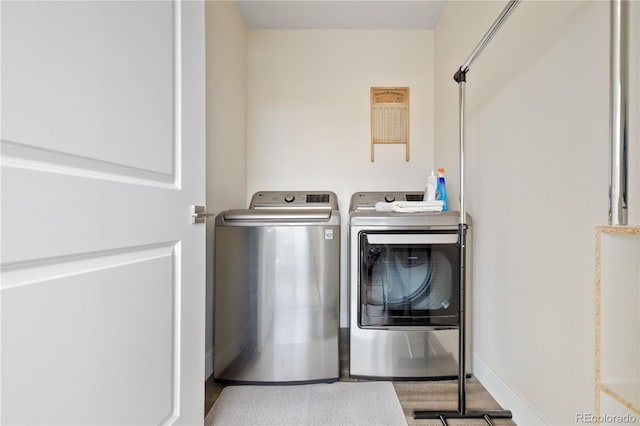 laundry room featuring separate washer and dryer and laundry area