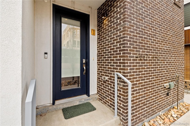 property entrance with brick siding