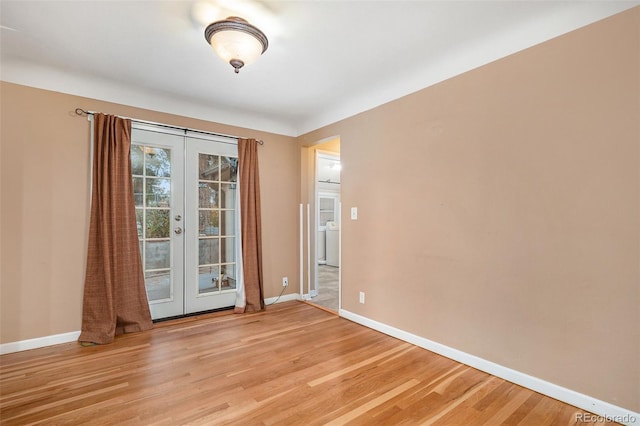 unfurnished room with french doors and light wood-type flooring