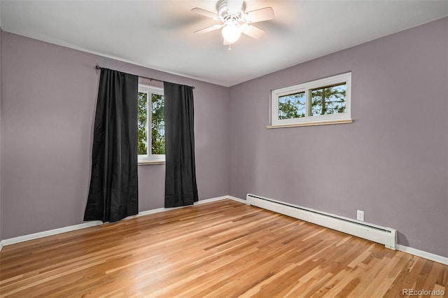 unfurnished room featuring baseboard heating, light hardwood / wood-style floors, and ceiling fan