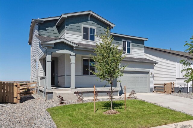 view of front of house featuring a garage and a front lawn