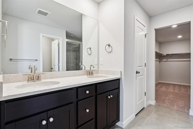 bathroom with vanity, walk in shower, and tile patterned floors