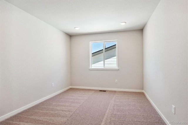 unfurnished room with light carpet