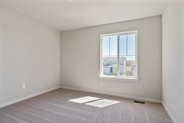 unfurnished room with a healthy amount of sunlight and carpet