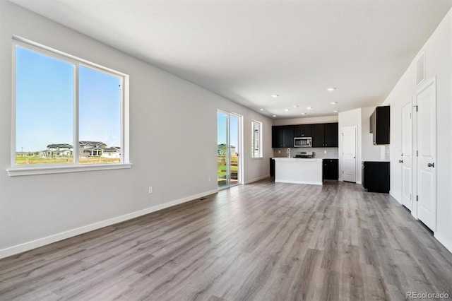 unfurnished living room featuring light wood-type flooring