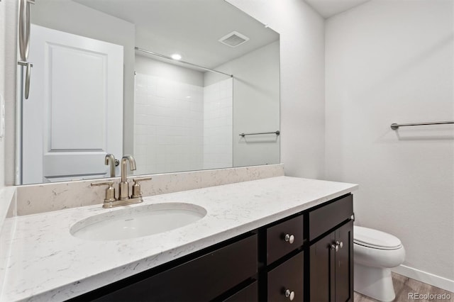 bathroom featuring vanity, toilet, wood-type flooring, and walk in shower