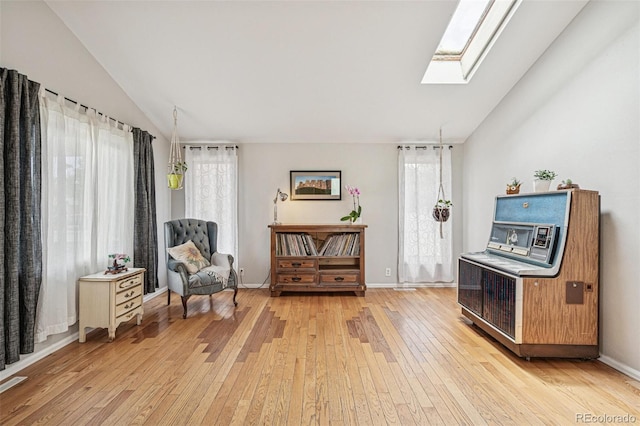 280 Pierce St, Erie, CO 80516 - living area with a skylight, light wood finished floors, vaulted ceiling, and baseboards