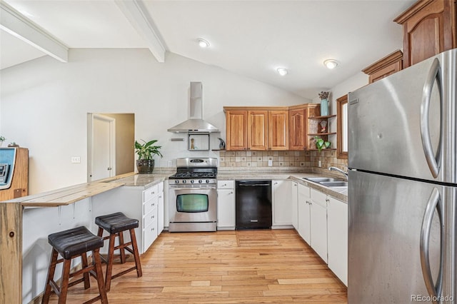 280 Pierce St, Erie, CO 80516 - kitchen with appliances with stainless steel finishes, wall chimney range hood, a peninsula, light wood finished floors, and tasteful backsplash