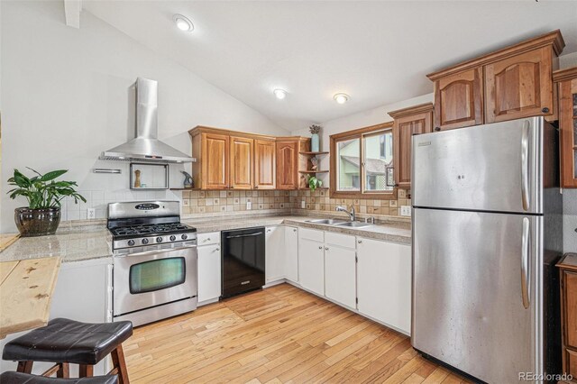 280 Pierce St, Erie, CO 80516 - kitchen featuring stainless steel appliances, wall chimney exhaust hood, a sink, lofted ceiling, and backsplash