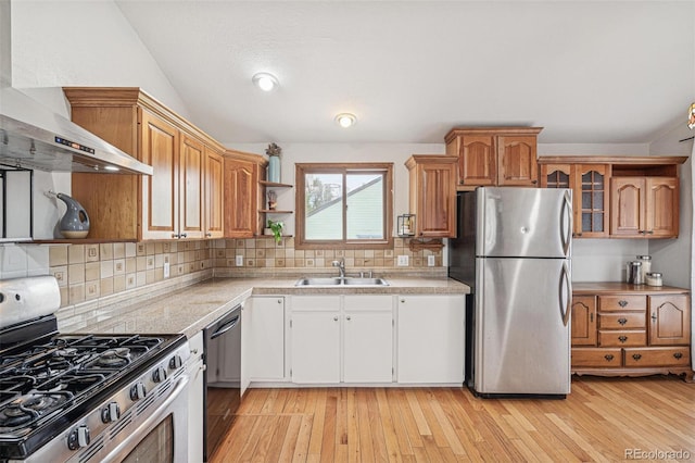 280 Pierce St, Erie, CO 80516 - kitchen featuring appliances with stainless steel finishes, a sink, wall chimney range hood, light countertops, and open shelves
