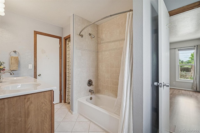280 Pierce St, Erie, CO 80516 - full bath featuring shower / bath combo with shower curtain, tile patterned flooring, double vanity, and a textured ceiling