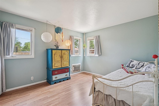 280 Pierce St, Erie, CO 80516 - bedroom with multiple windows, wood finished floors, and baseboards