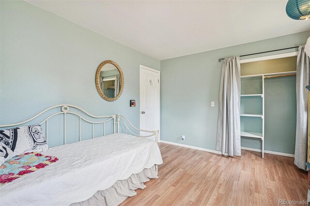 280 Pierce St, Erie, CO 80516 - bedroom with wood finished floors, baseboards, and a closet