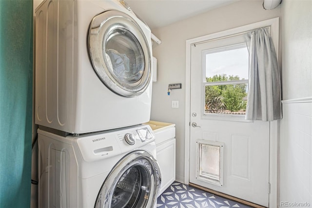 280 Pierce St, Erie, CO 80516 - laundry room with stacked washer and clothes dryer, cabinet space, and light flooring