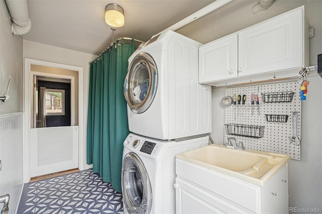 280 Pierce St, Erie, CO 80516 - laundry room featuring stacked washer / dryer and cabinet space