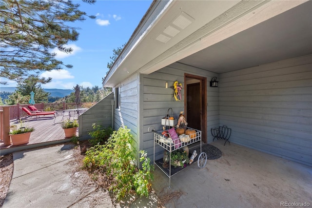 view of patio / terrace with a deck with mountain view