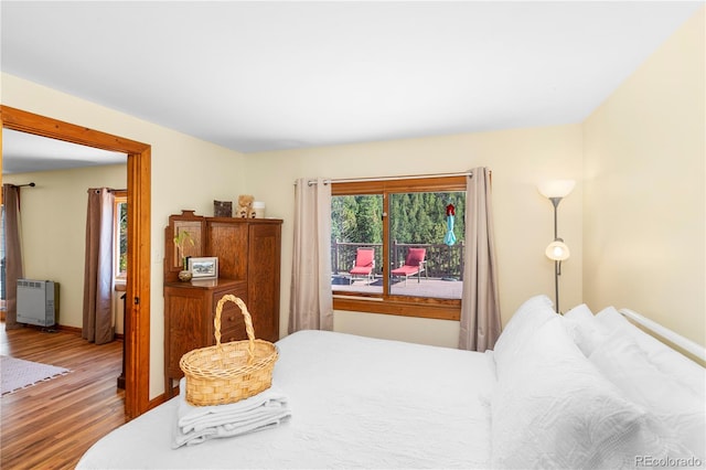 bedroom featuring hardwood / wood-style floors and heating unit