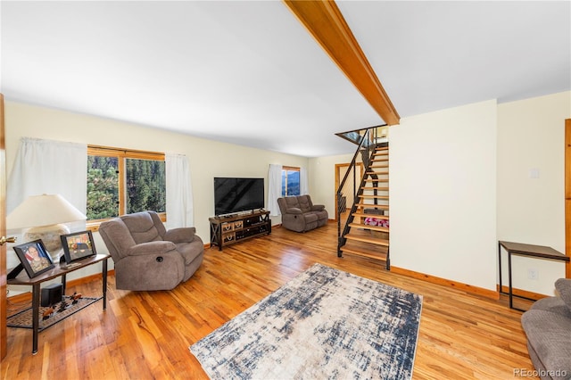 living room with hardwood / wood-style flooring and beam ceiling